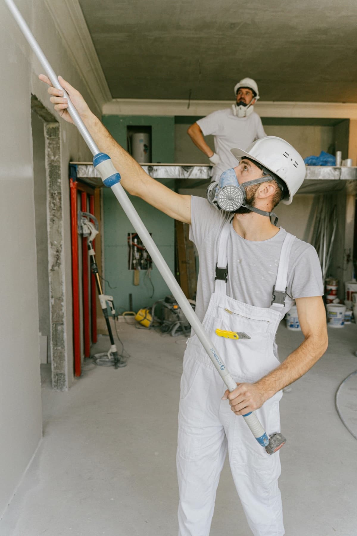 Professional renovation workers completing an indoor home-service project.