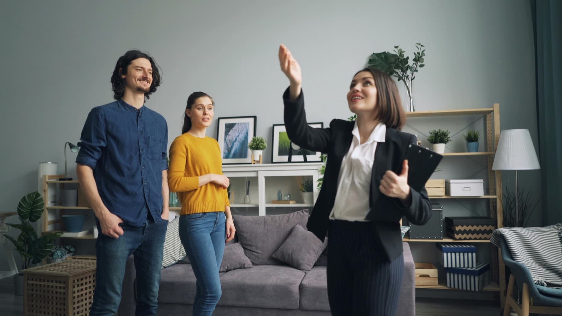 A real estate agent showing a home to prospective buyers.